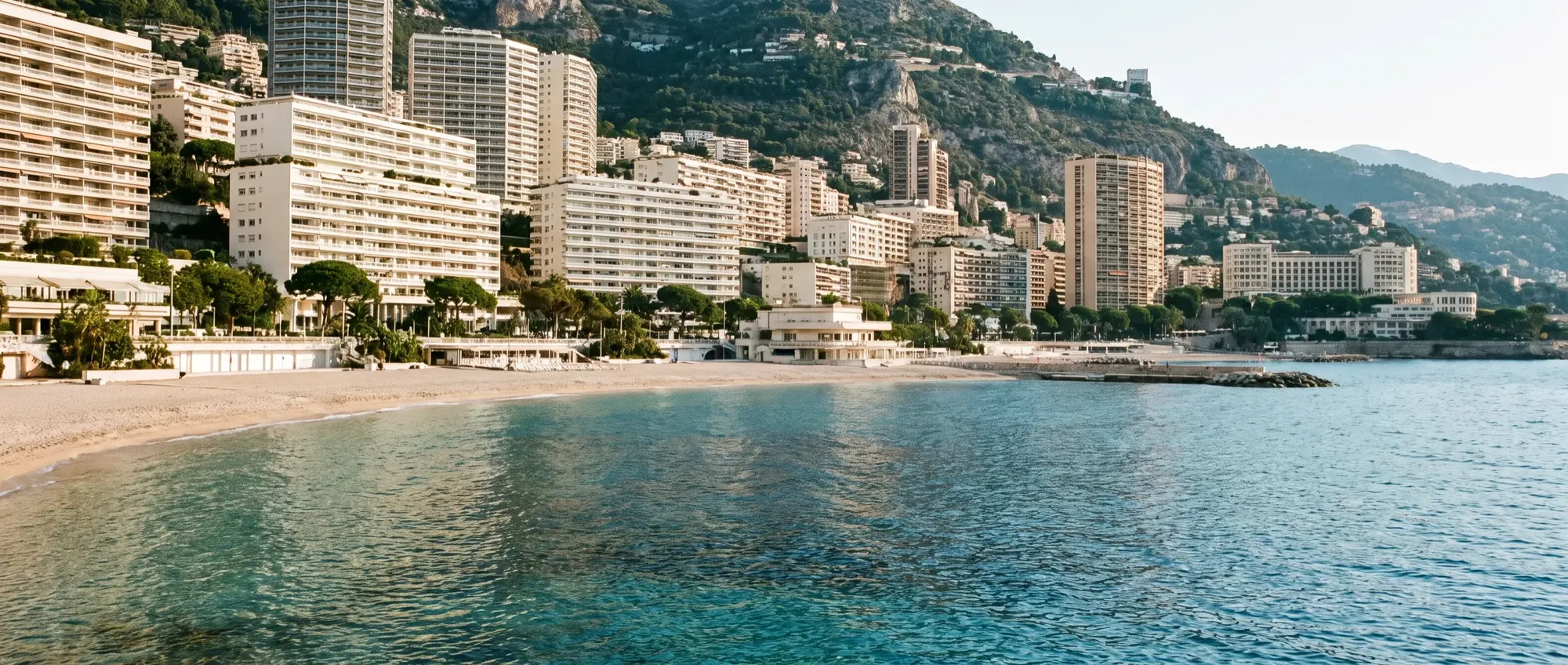 The Larvotto shoreline of Monaco seen from the water on a summer afternoon.